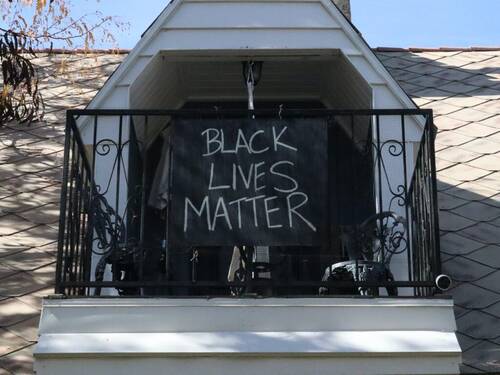 A Black Lives Matter sign displayed on a balcony.